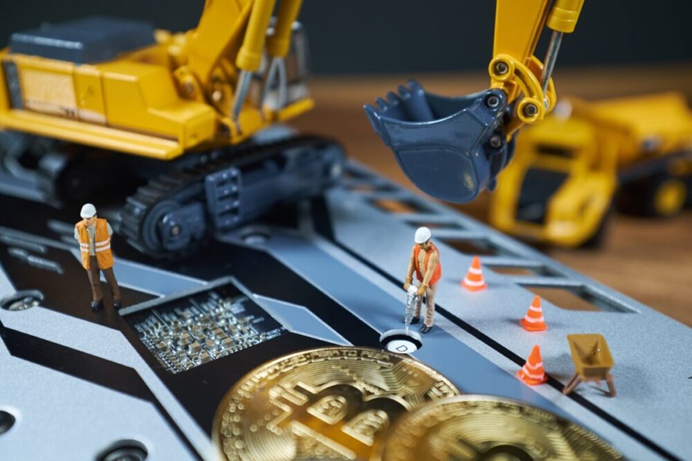 A little miner is digging on graphic card with golden coin. bitc