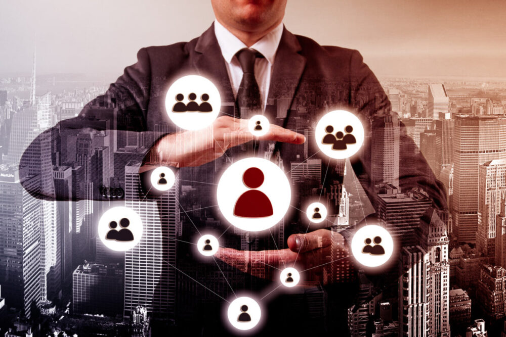 Hand carrying businessman icon network – HR,HRM,MLM, teamwork and leadership concept