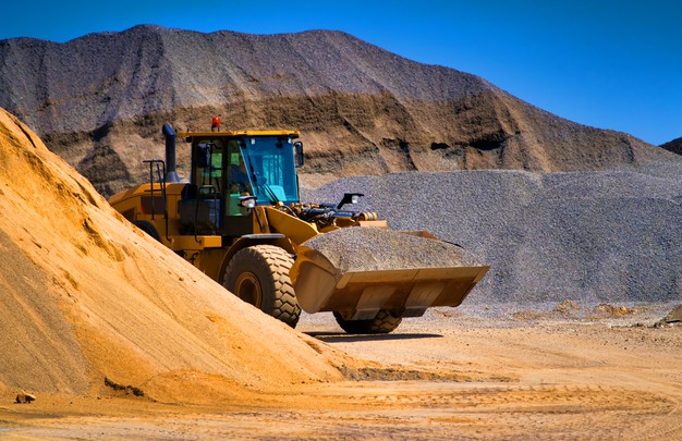 sand-quarry-excavating-equipment-bulldozer-with-heap-sand-gravel_116317-3233