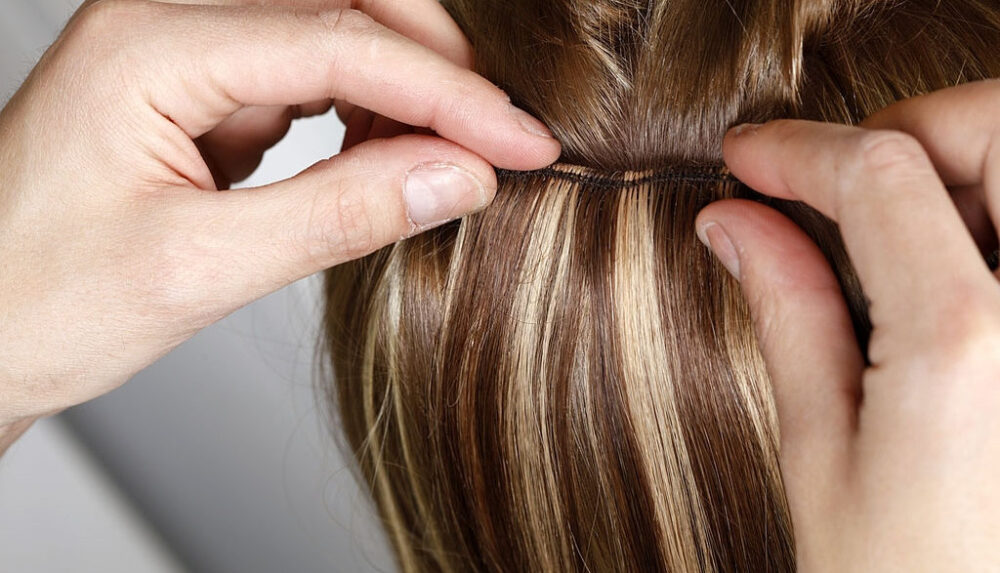 Hairstylist Applying Hair Extensions