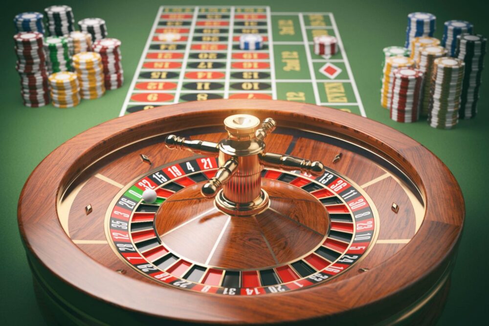 casino-roulette-wheel-with-casino-chips-on-green-t-P96BR7D-min-1568×1045